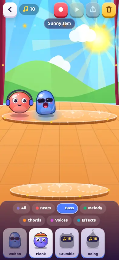 Two buddies on stage, a red one with headphones and a blue one with sunglasses, singing